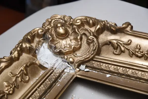 Kittung an einem Ornament eines historischen Goldrahmens